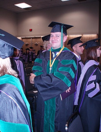 Dr. Kasey Hill in his med school graduation gown