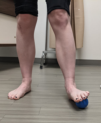 lateral foot mobilization Standing on the ball placed at this location, the runner gently rotates their upper body side to side.