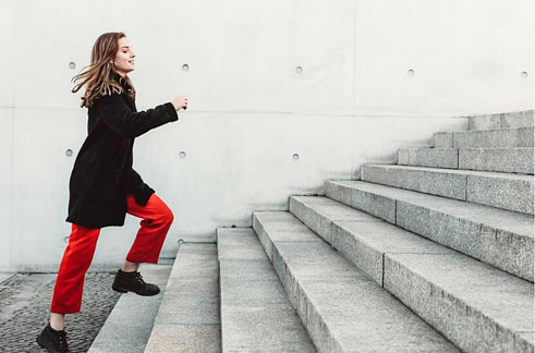 Lady running up the stairs A lady in casual dress running up stairs